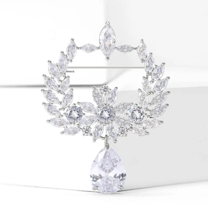 Elegant silver olive branch wreath brooch with sparkling zircons and a teardrop pendant