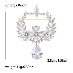 Elegant gold olive branch wreath brooch with sparkling zircons and a teardrop pendant