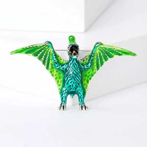 Detailed macro view of the pterosaur brooch with green enamel finish and alloy texture