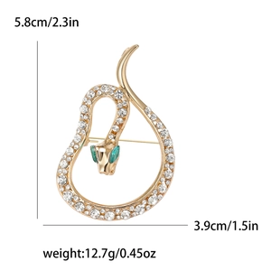 Luxury gold snake brooch with sparkling crystals and green gem eyes on white background