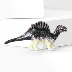 Detailed close-up of a Spinosaurus brooch with dark green paint on white geometric blocks