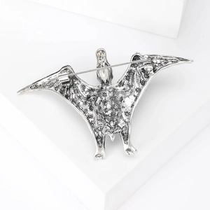 Detail view of the vintage silver pterosaur brooch showing the metal pin clasp mechanism