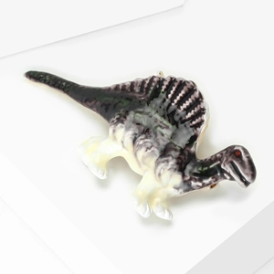 Detail of a spinosaurus brooch with gradient purple enamel and shiny metallic finish