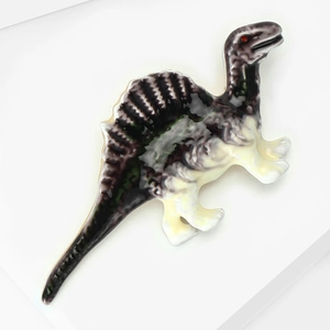 Close-up of a detailed purple spinosaur enamel brooch with crystal accents and glossy finish