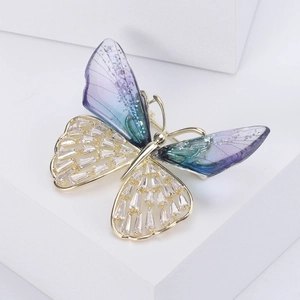 Detail of crystal butterfly brooch showing gradient resin wings and inlaid zircons
