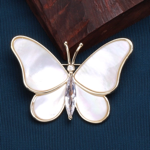 Elegant gold butterfly brooch with natural mother of pearl wings and zircon stones