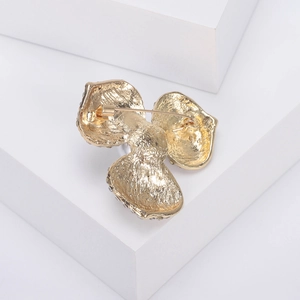 Vue arrière de la broche fleur dorée avec bords en strass et fermoir de sécurité fiable