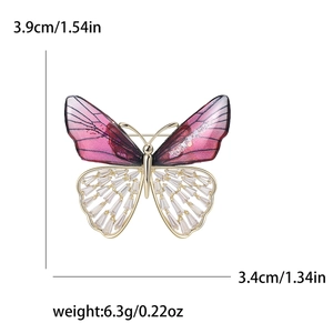 Elegant crystal butterfly brooch with purple resin wings and gold-plated metal base