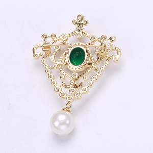 Detailed back view of vintage gold brooch showing safety pin and hollow floral pattern