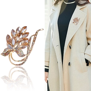 Vintage gold leaf brooch with champagne crystals and rhinestones shown on a model