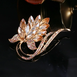 Close-up of vintage gold alloy brooch with champagne crystal petals and rhinestones