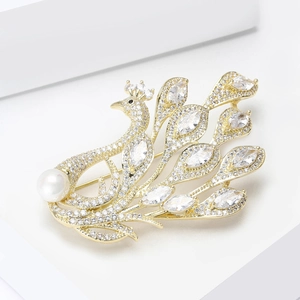 Elegant gold peacock brooch with sparkling white cubic zirconia and a white pearl accent