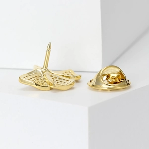 Golden bow brooch with micro-pave cubic zirconia and secure butterfly clasp fastener