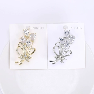 Elegant floral bouquet brooch set with sparkling cubic zirconia stones in gold and silver