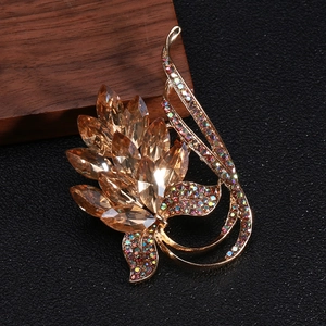 Close-up of vintage champagne crystals and rainbow rhinestones on a gold brooch