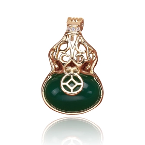 Detail view of gold gourd earring with hollow coin pattern and green nephrite jade stone