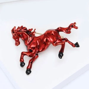 Detailed view of red enamel horse brooch in a dynamic running pose for suits