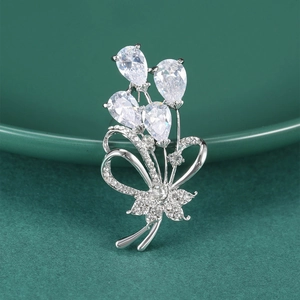 Elegant silver flower bouquet brooch with sparkling pear-cut cubic zirconia and bow detail
