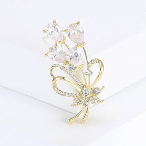 Macro detail of bouquet brooch with pear-shaped cubic zirconia and crystal pavé ribbon