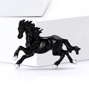 Detail of creative black enamel running horse brooch with metallic silver accents