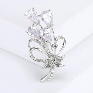Detail of silver bouquet brooch with teardrop crystals and a pavé-set diamond bow