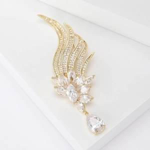 Elegant angel wing brooch with gold plating and sparkling cubic zirconia crystals