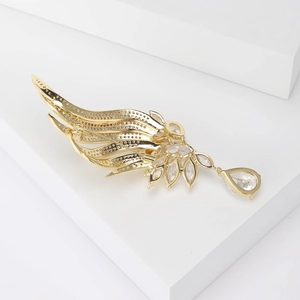 Elegant gold angel wing brooch with sparkling cubic zirconia and teardrop crystal pendant
