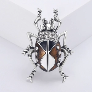 Close-up of luxury insect brooch with sparkling diamonds and enamel craftsmanship