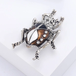 Detailed macro view of an elegant beetle brooch with silver alloy and crystal inlays
