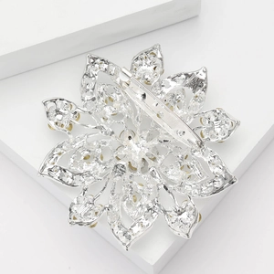 Detailed back view of silver alloy flower brooch showing the secure metal pin fastener