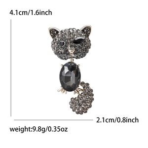 Detailed view of rhinestone cat brooch with black oval stone and size measurements