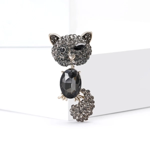 Elegant cat brooch featuring grey rhinestones and a large black faceted gemstone