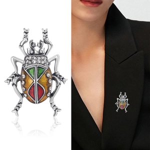 Luxurious beetle brooch with colorful enamel and crystal inlays shown on white and model