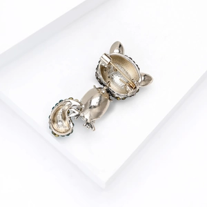 Detail view of the silver alloy squirrel brooch back with pin clasp and colorful rhinestones