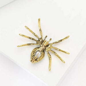 Detailed back view of vintage gold spider brooch showing pin fastener and metal texture