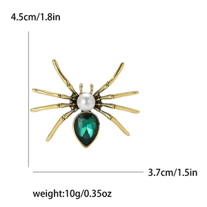 Vintage spider brooch with green gemstone and pearl detail for suits and jackets