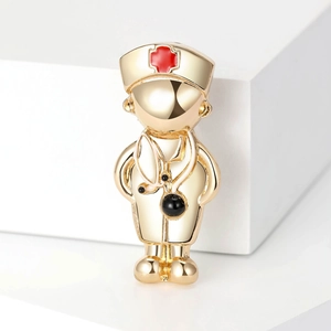 Macro shot of gold doctor brooch with red cross hat and stethoscope on a white stand
