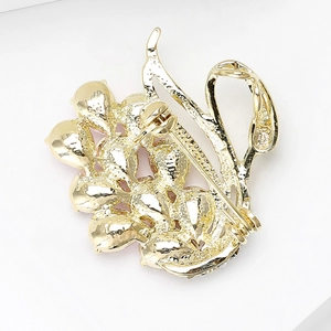 Back view of a luxury gold plated swan brooch with a secure safety pin fastener