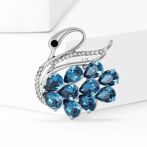Elegant silver swan brooch with deep blue pear-cut crystal and white zircon micro-paving