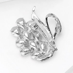 Detailed macro view showing the secure rotating safety pin clasp on the brooch back