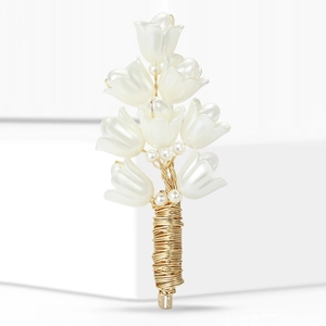 Elegant lily of the valley brooch with mother of pearl petals and gold metal wire on white stand