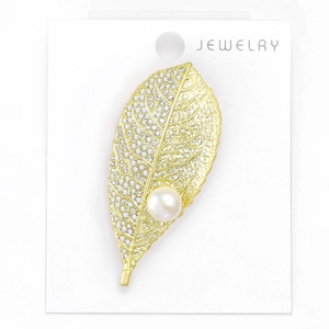 Macro detail of leaf brooch with freshwater pearl and pavé cubic zirconia inlay