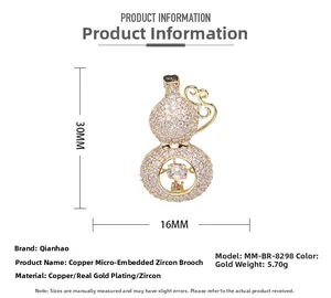 Detail view of gold gourd brooch with copper base and handset cubic zirconia stones
