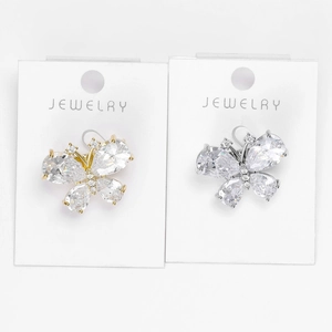 Macro detail of mini butterfly brooches with clear zircon stones on display cards