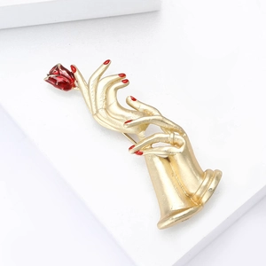Artistic gold hand holding a red rose enamel brooch pin with matte finish for fashion