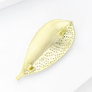 Detail view of the gold leaf brooch back featuring matte finish and secure rotary pin clasp