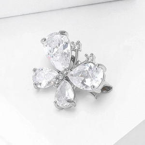 Macro view of silver butterfly brooch with pear-shaped clear zircon stones and claw setting