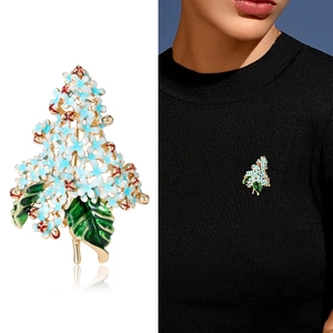 Blue hydrangea flower brooch with enamel petals and gold plating on model and white backdrop