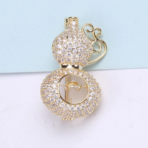 Macro detail of luxury copper gourd brooch with pave-set sparkling zircon crystals