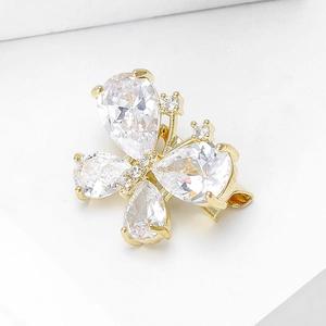 Macro view of mini gold butterfly brooch featuring pear-cut clear gems and fine crystals